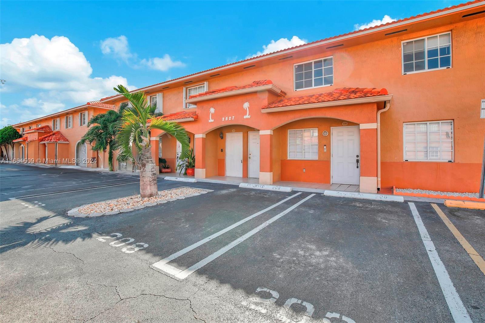 2527 West 76th Street, Unit 208 Hialeah, FL 33016 - Photo 3 of 37 a front view of a house with a garage
