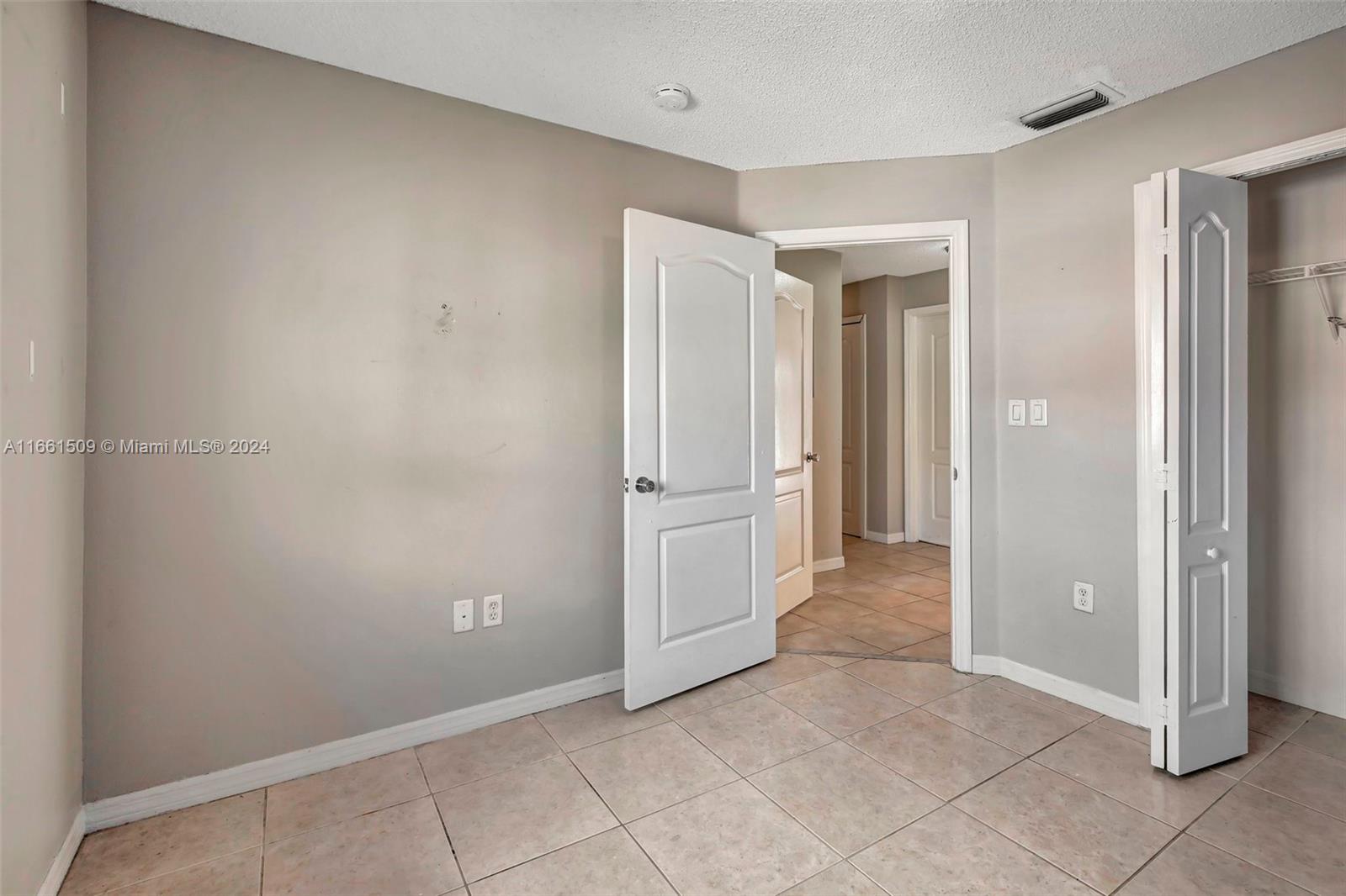 2527 West 76th Street, Unit 208 Hialeah, FL 33016 - Photo 31 of 37 an empty room with windows