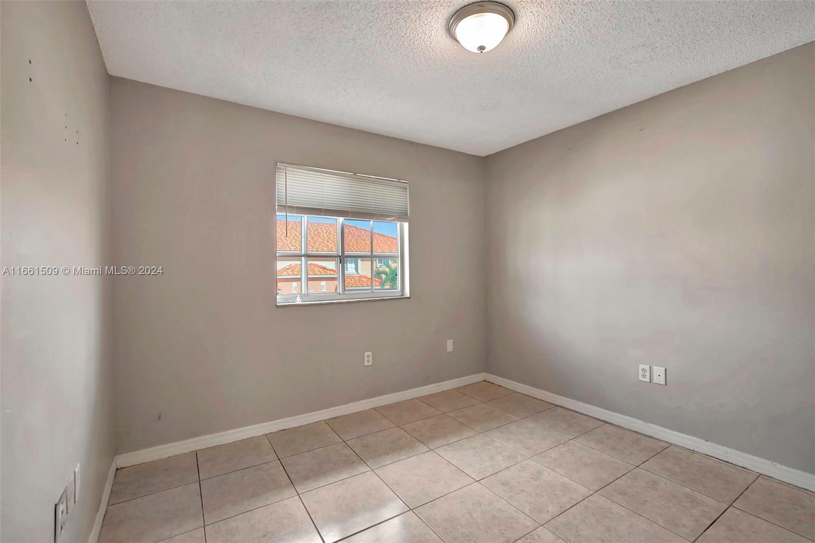 2527 West 76th Street, Unit 208 Hialeah, FL 33016 - Photo 34 of 37 an empty room with a window