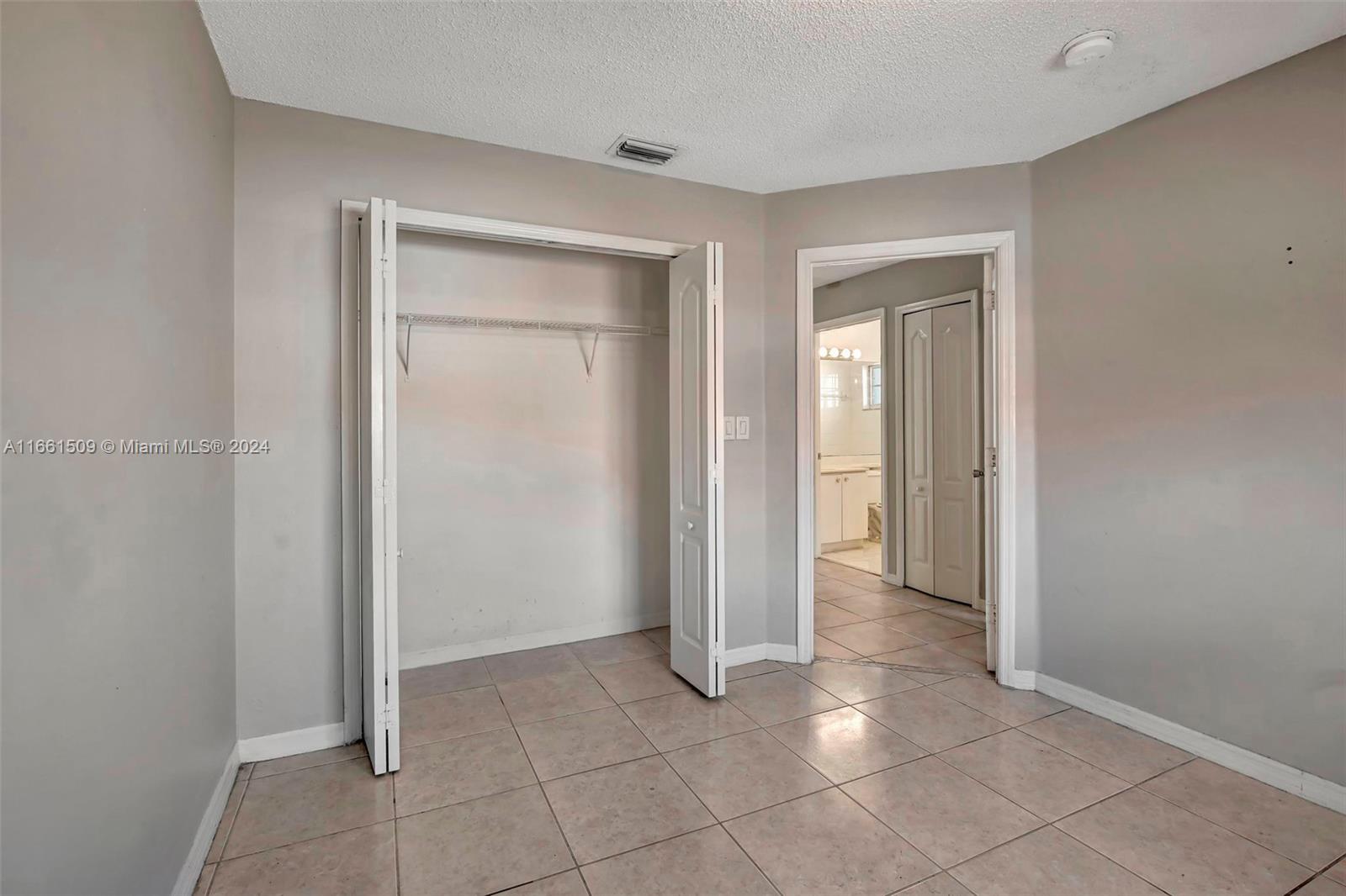 2527 West 76th Street, Unit 208 Hialeah, FL 33016 - Photo 36 of 37 a view of an empty room and closet area