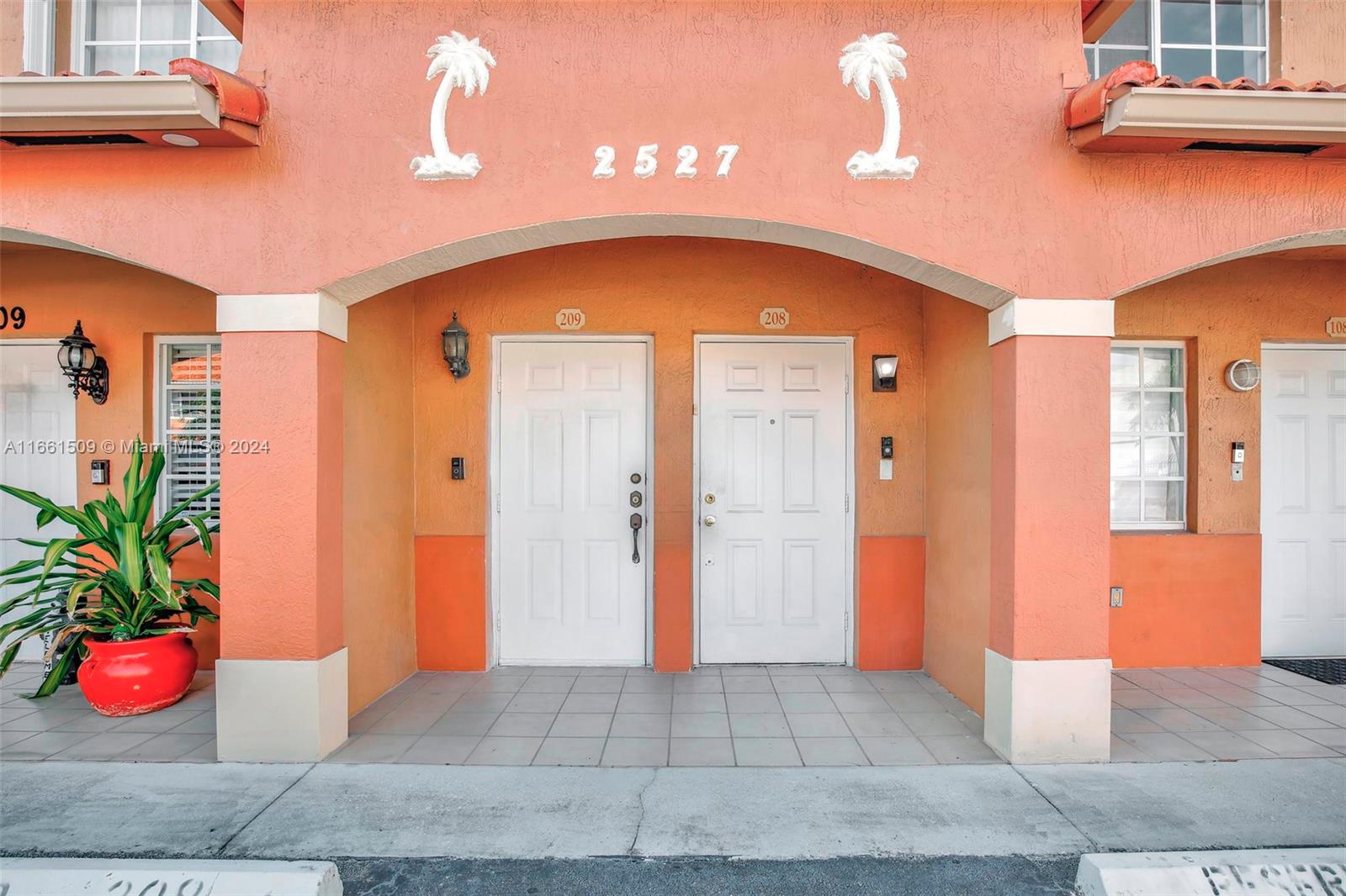 2527 West 76th Street, Unit 208 Hialeah, FL 33016 - Photo 4 of 37 a front view of a house with entryway
