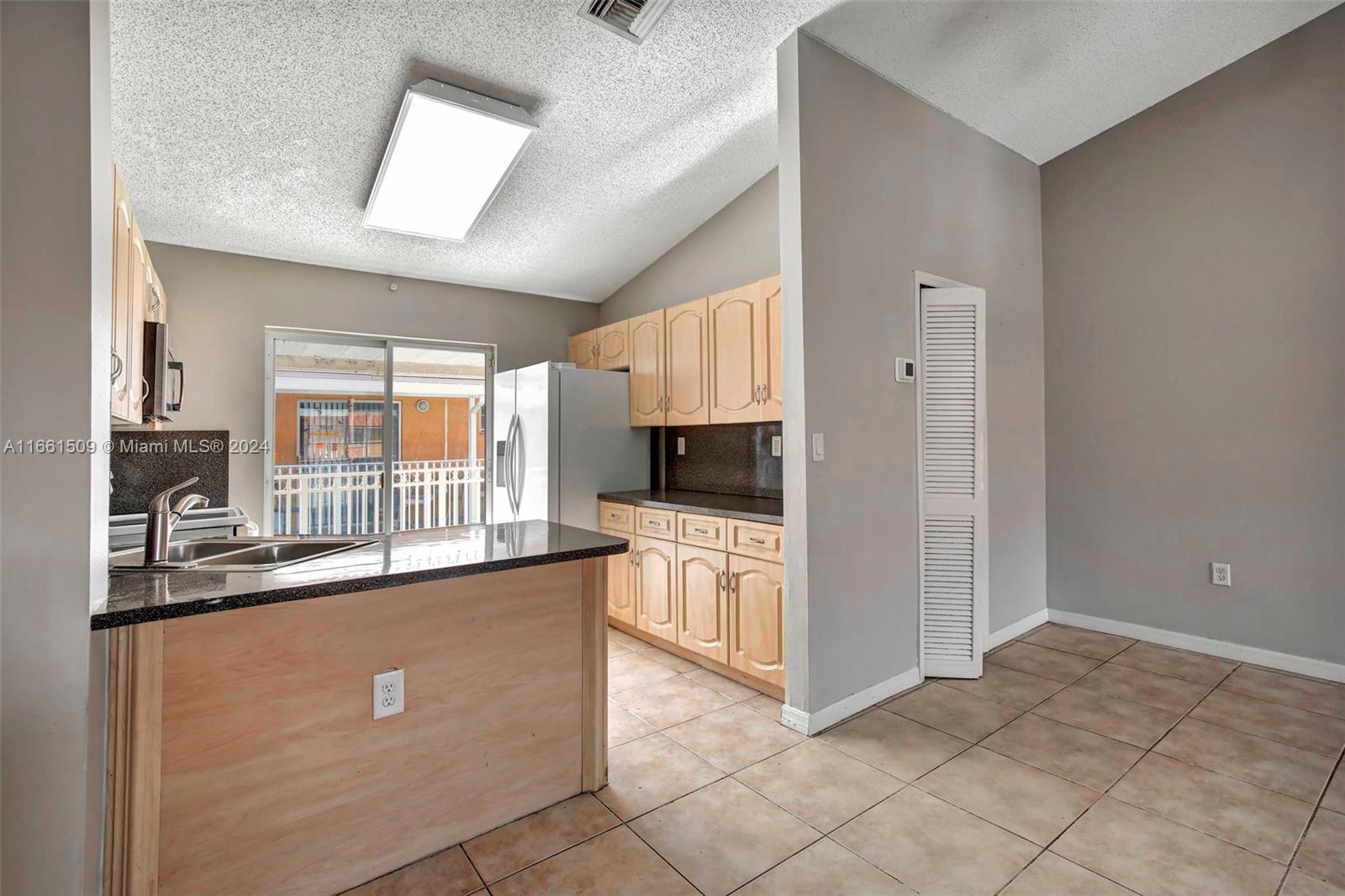 2527 West 76th Street, Unit 208 Hialeah, FL 33016 - Photo 6 of 37 a kitchen with stainless steel appliances granite countertop a refrigerator and a stove