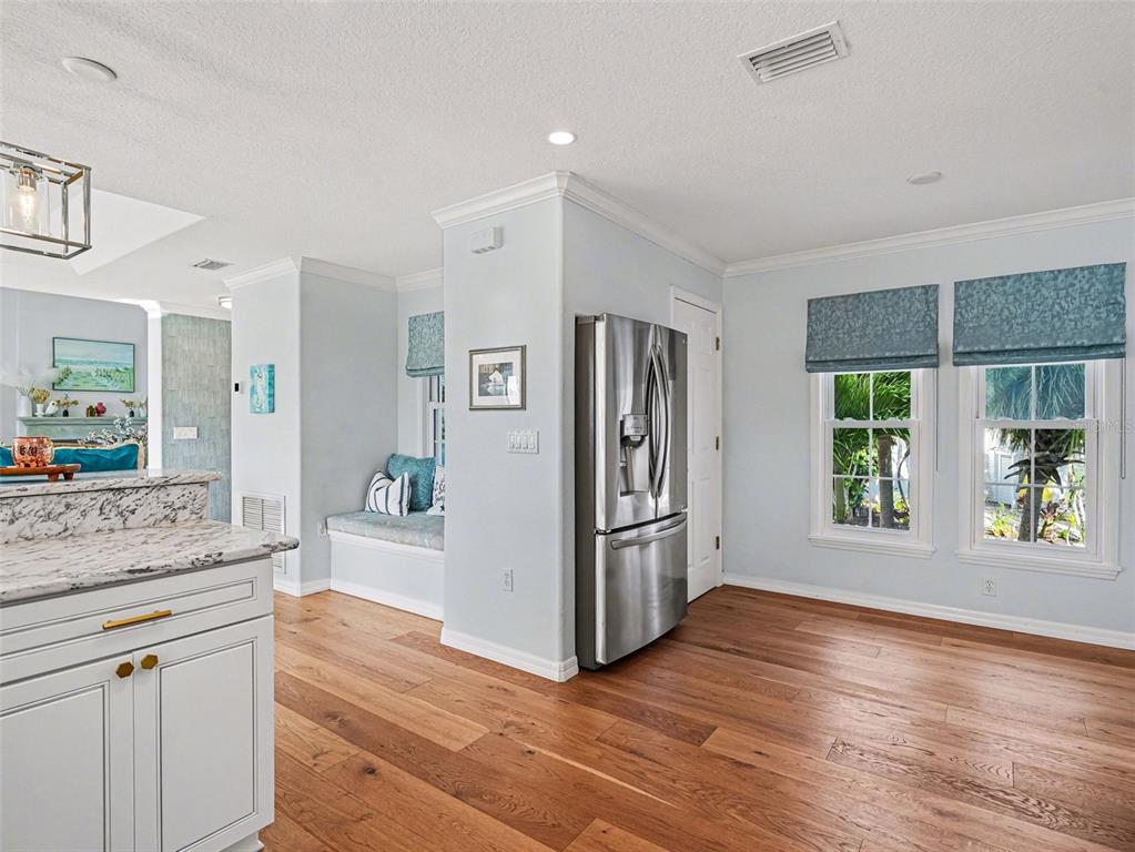 129 Hammock Road Anna Maria, FL 34216 - Photo 13 of 52 a view of a kitchen cabinets and wooden floor