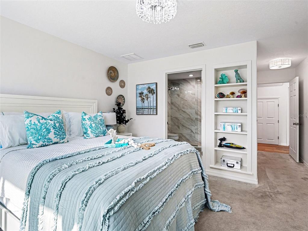 129 Hammock Road Anna Maria, FL 34216 - Photo 20 of 52 a bedroom with a bed and a chandelier