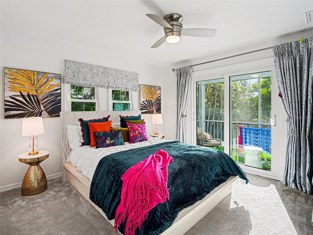 129 Hammock Road Anna Maria, FL 34216 - Photo 22 of 52 a bedroom with a bed and a window