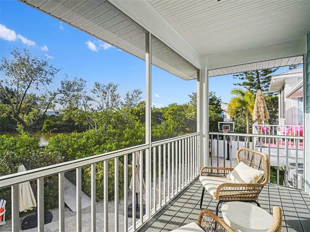 129 Hammock Road Anna Maria, FL 34216 - Photo 25 of 52 a view of a balcony with chair and table