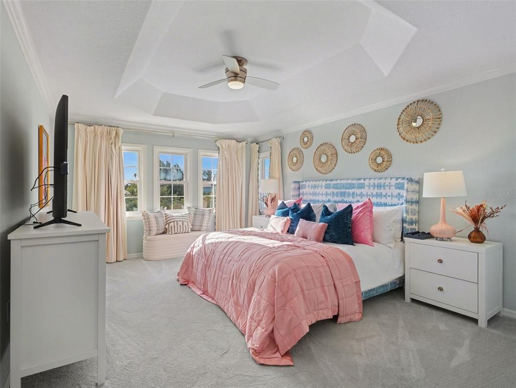 129 Hammock Road Anna Maria, FL 34216 - Photo 27 of 52 a bedroom with a large bed and a flat tv screen