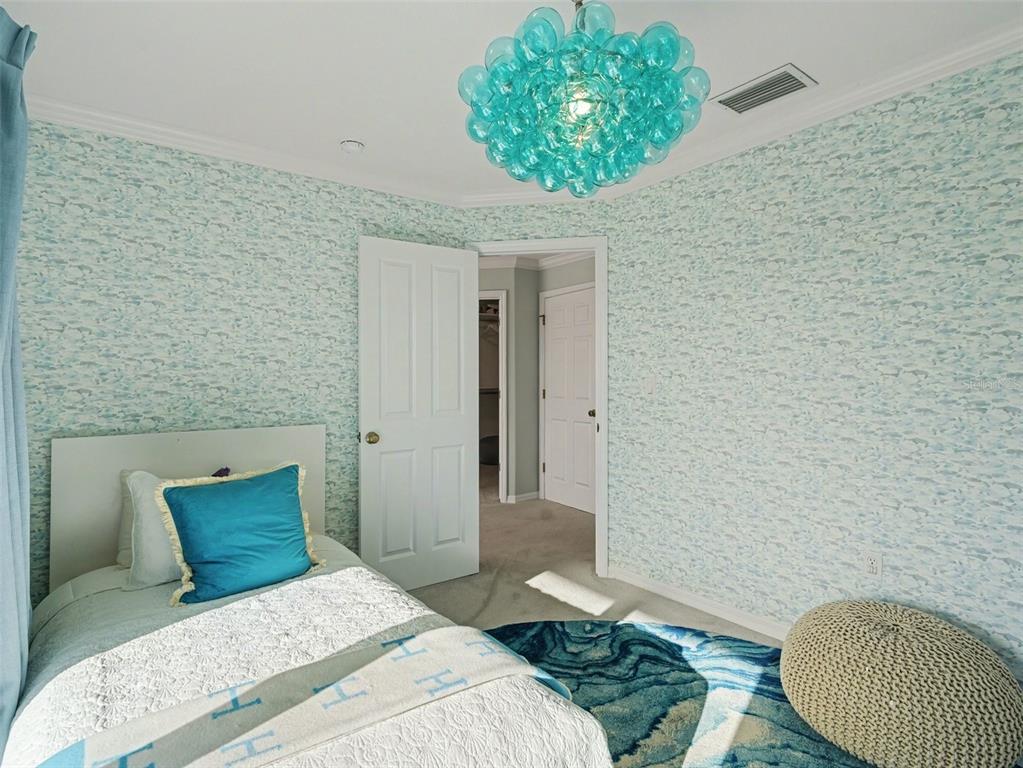 129 Hammock Road Anna Maria, FL 34216 - Photo 31 of 52 a bedroom with a bed and a painting on the wall