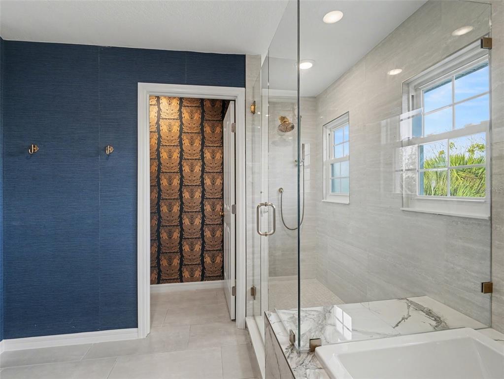 129 Hammock Road Anna Maria, FL 34216 - Photo 33 of 52 a bathroom with a bathtub and a shower