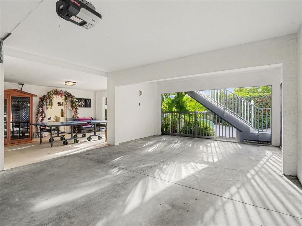 129 Hammock Road Anna Maria, FL 34216 - Photo 37 of 52 a view of a livingroom with furniture and a garage