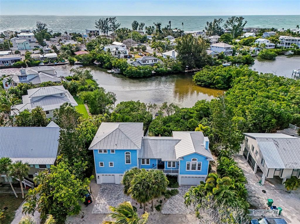 129 Hammock Road Anna Maria, FL 34216 - Photo 4 of 52 an aerial view of a house with a garden and lake view