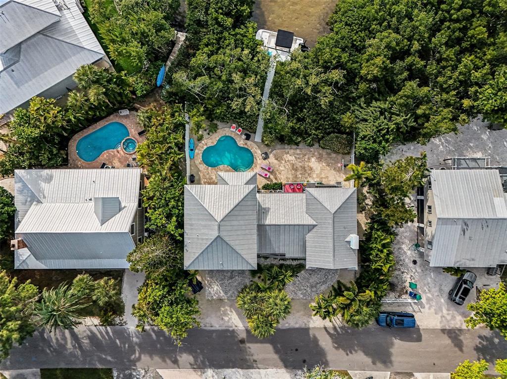 129 Hammock Road Anna Maria, FL 34216 - Photo 49 of 52 an aerial view of a house with a yard and a garden