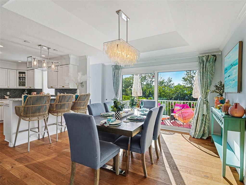 129 Hammock Road Anna Maria, FL 34216 - Photo 9 of 52 a view of a dining room with furniture wooden floor and chandelier