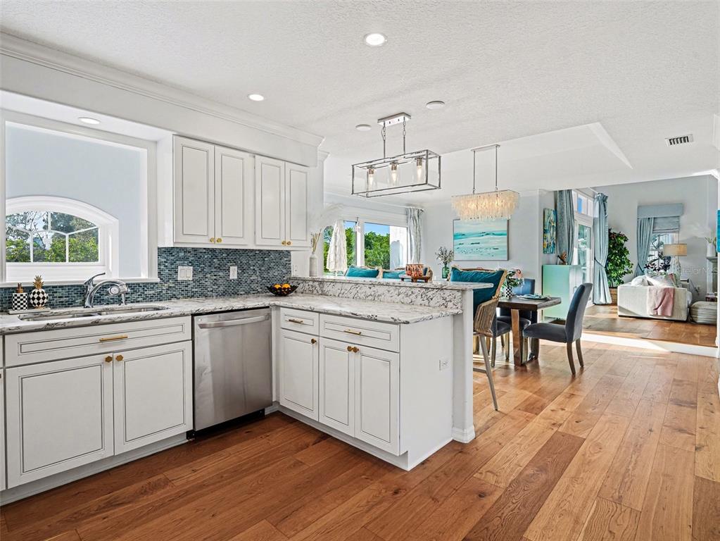 129 Hammock Road Anna Maria, FL 34216 - Photo 10 of 52 a kitchen with granite countertop white cabinets and white appliances