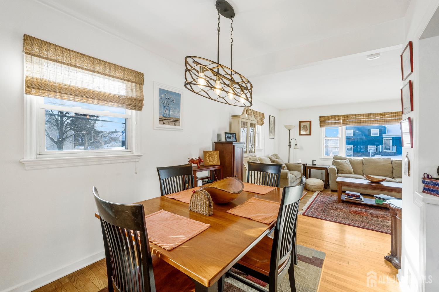 241 Cook Avenue Middlesex, NJ 08846 - Photo 8 of 33 a dining room with furniture a chandelier and wooden floor