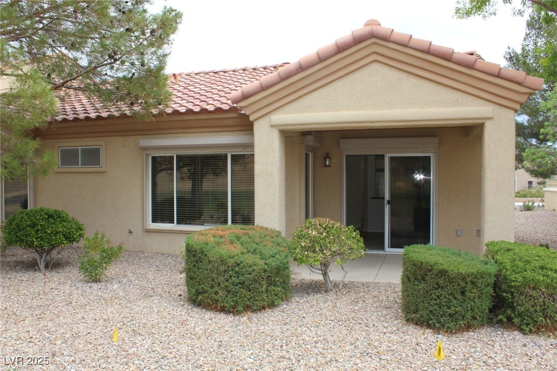 2013 Capestone Street Las Vegas, NV 89134 - Photo 15 of 40 Back of house featuring stucco siding and a tiled