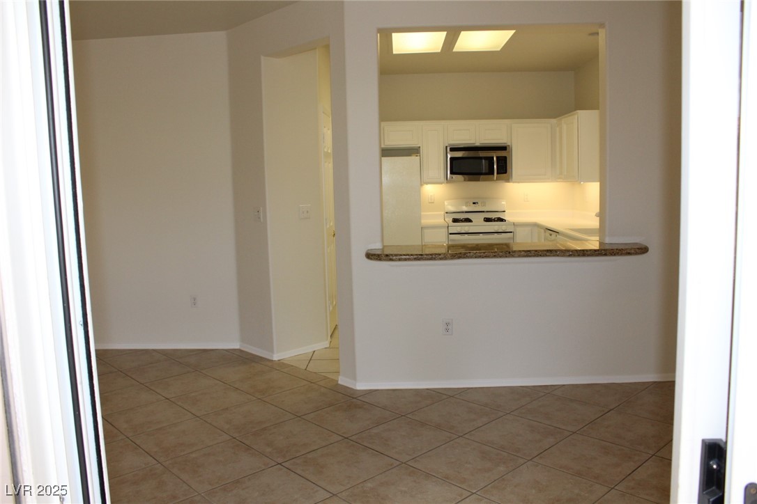 2013 Capestone Street Las Vegas, NV 89134 - Photo 16 of 40 Kitchen with light tile patterned floors, white ap