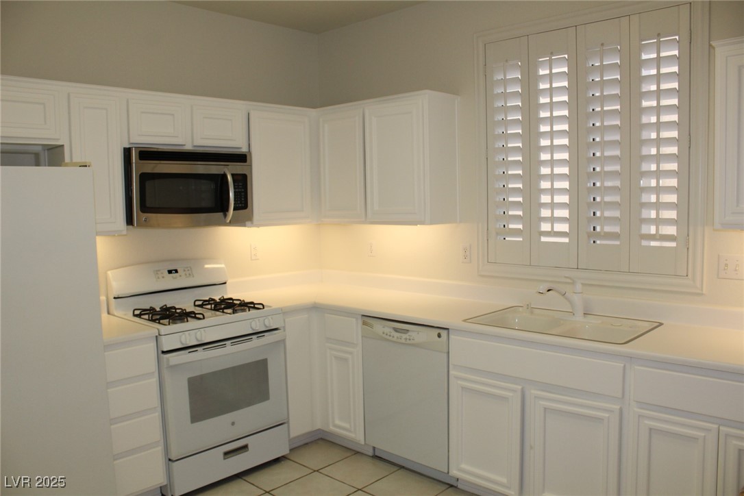 2013 Capestone Street Las Vegas, NV 89134 - Photo 10 of 40 Kitchen with a sink, white appliances, white cabin