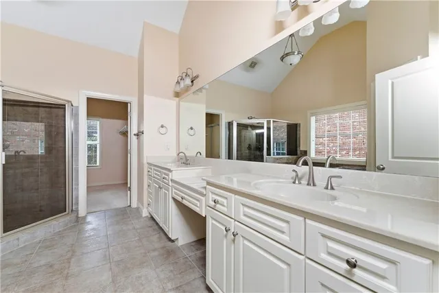a spacious bathroom with a granite countertop sink mirror and double