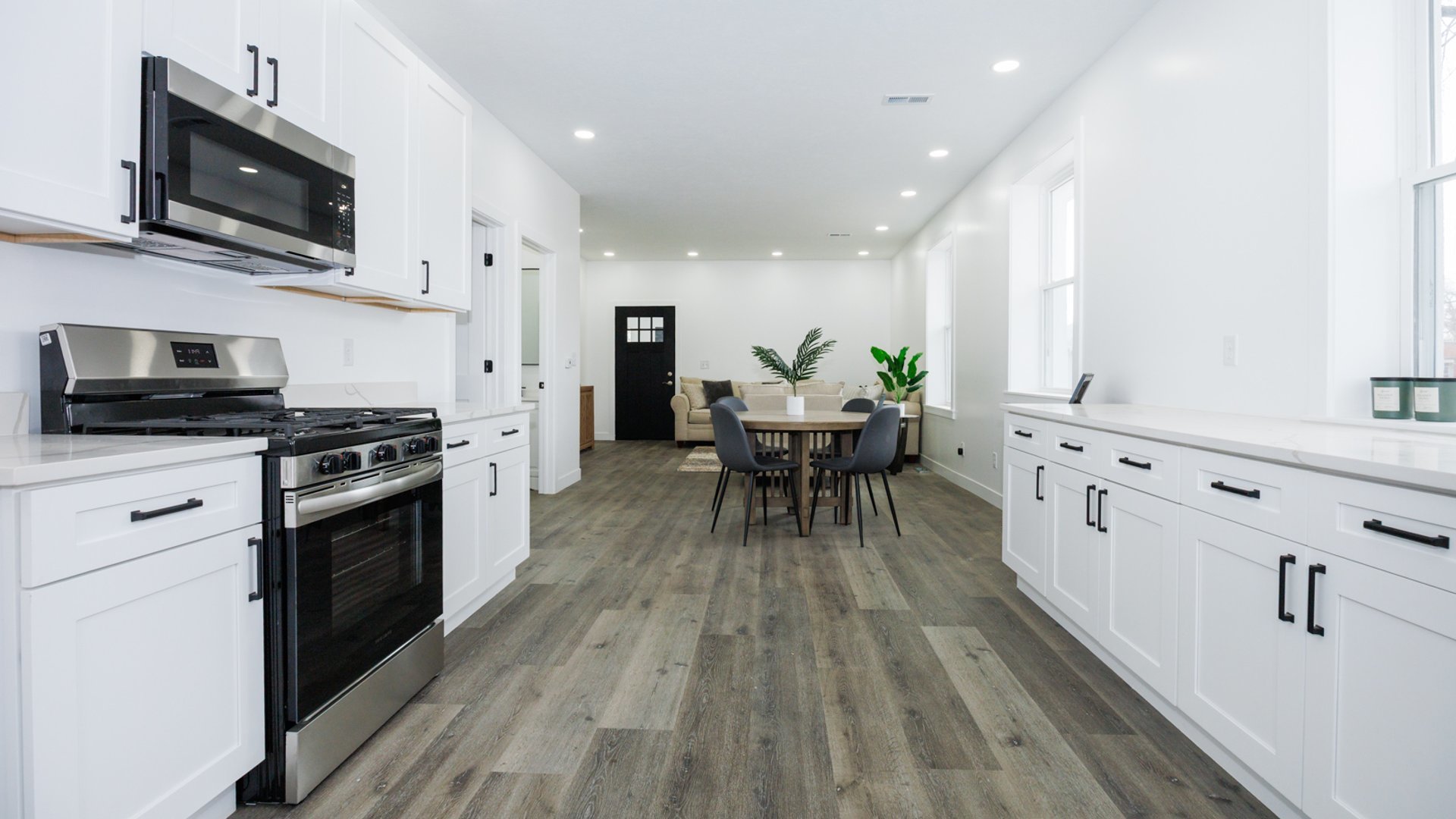 733 West Prairie Street Pontiac, IL 61764 - Photo 11 of 32 a kitchen with stainless steel appliances a microwave a stove a sink dishwasher a microwave oven with white cabinets and wooden floor