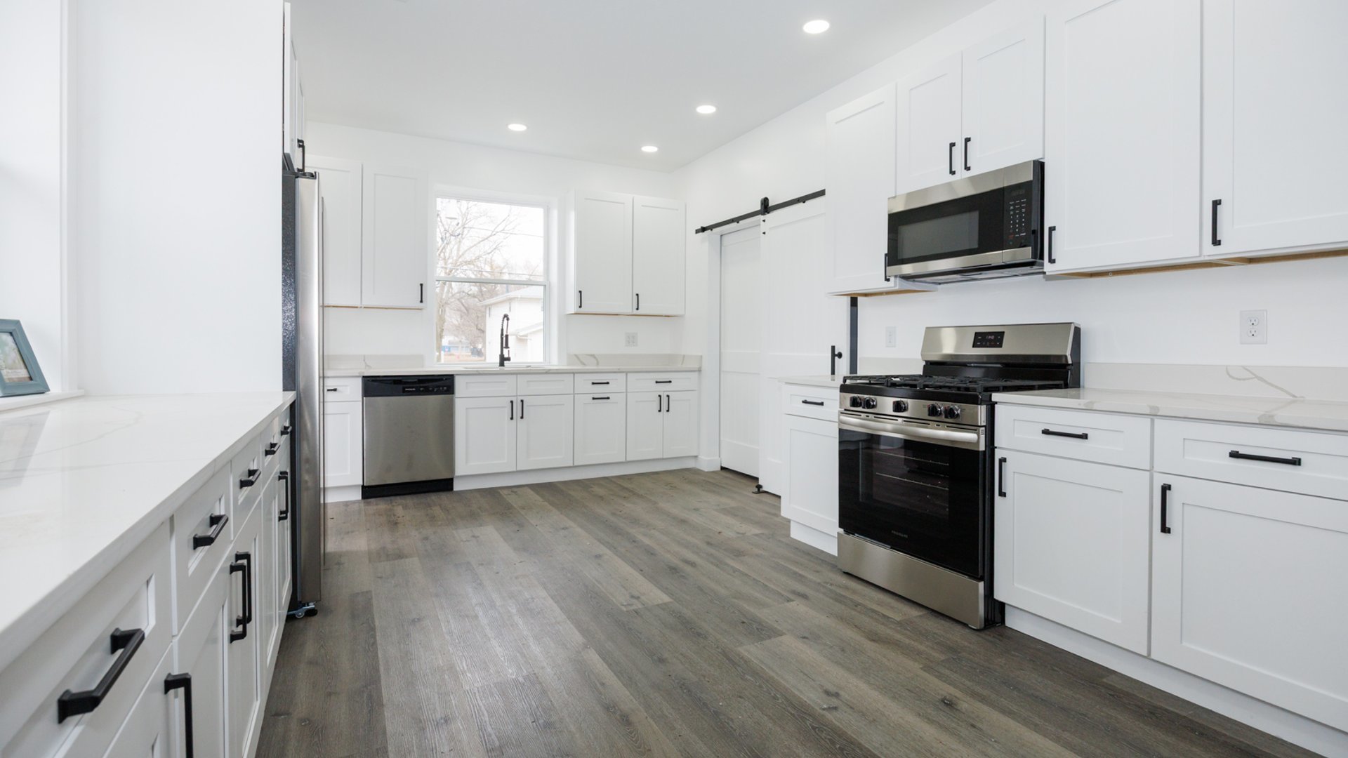 733 West Prairie Street Pontiac, IL 61764 - Photo 14 of 32 a kitchen with stainless steel appliances granite countertop a stove top oven a sink dishwasher and a refrigerator with wooden floor