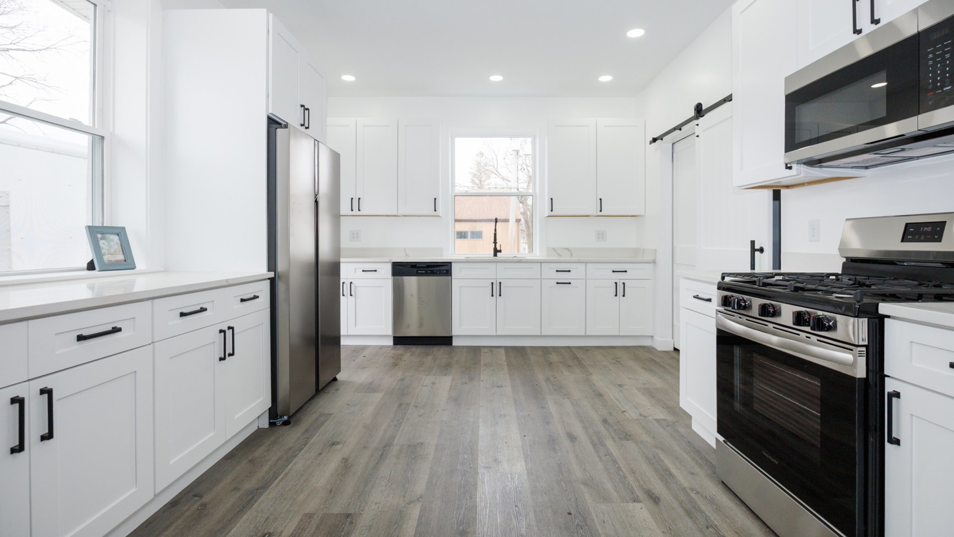 733 West Prairie Street Pontiac, IL 61764 - Photo 2 of 32 a kitchen with white cabinets stainless steel appliances and wooden floor