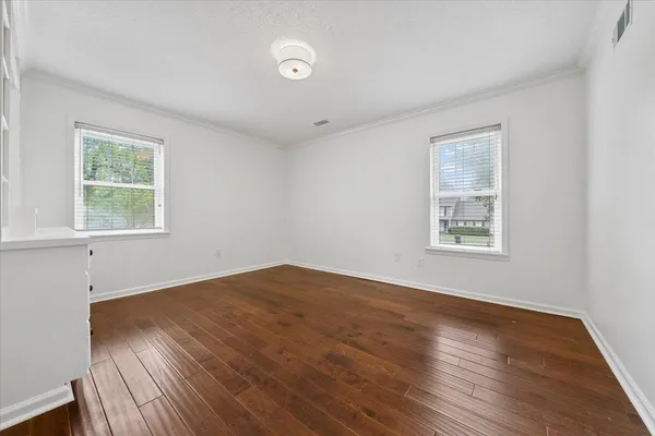 wooden floor in an empty room with window