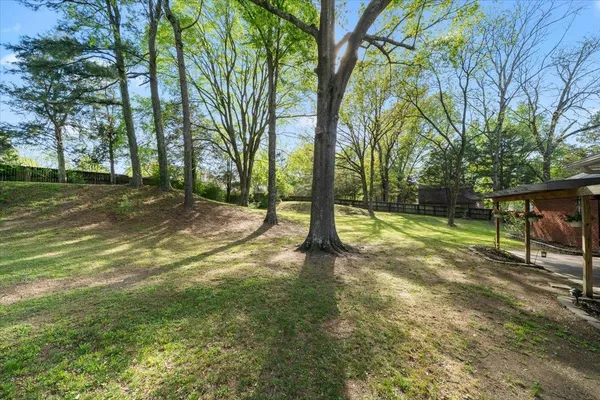 a view of a house with backyard and porch