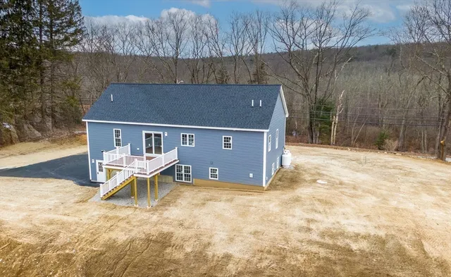 a view of house with yard and outdoor seating