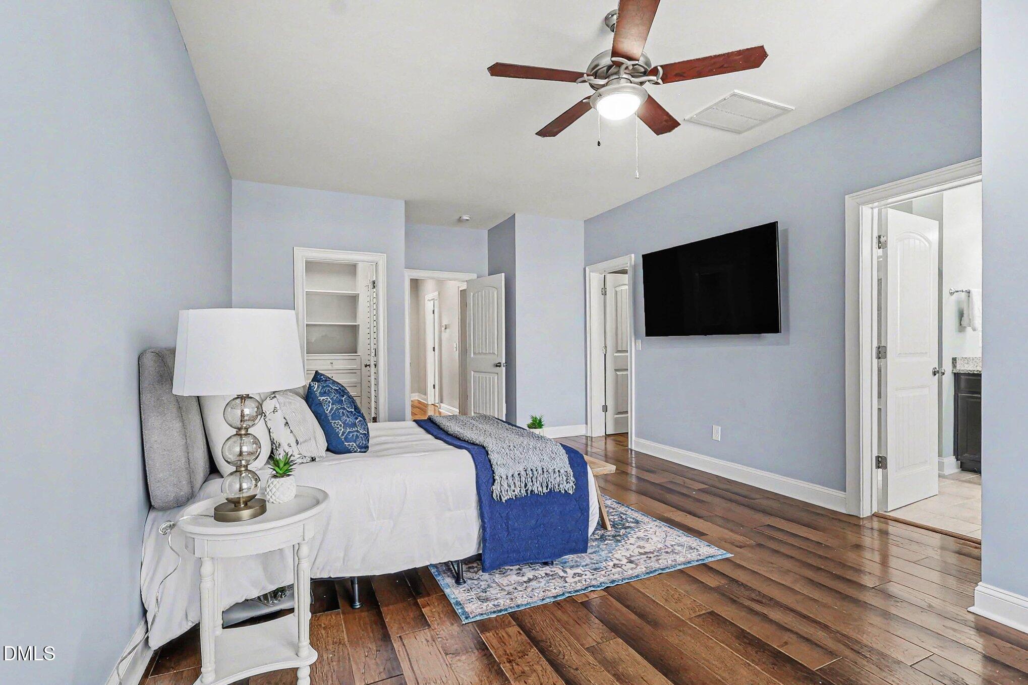 653 Fallon Grove Way Raleigh, NC 27608 - Photo 20 of 38 a bedroom with a bed and a flat screen tv