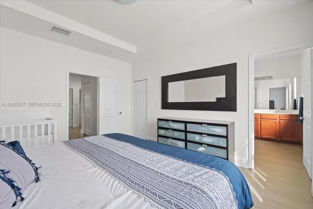 a bedroom with a bed and a view of kitchen