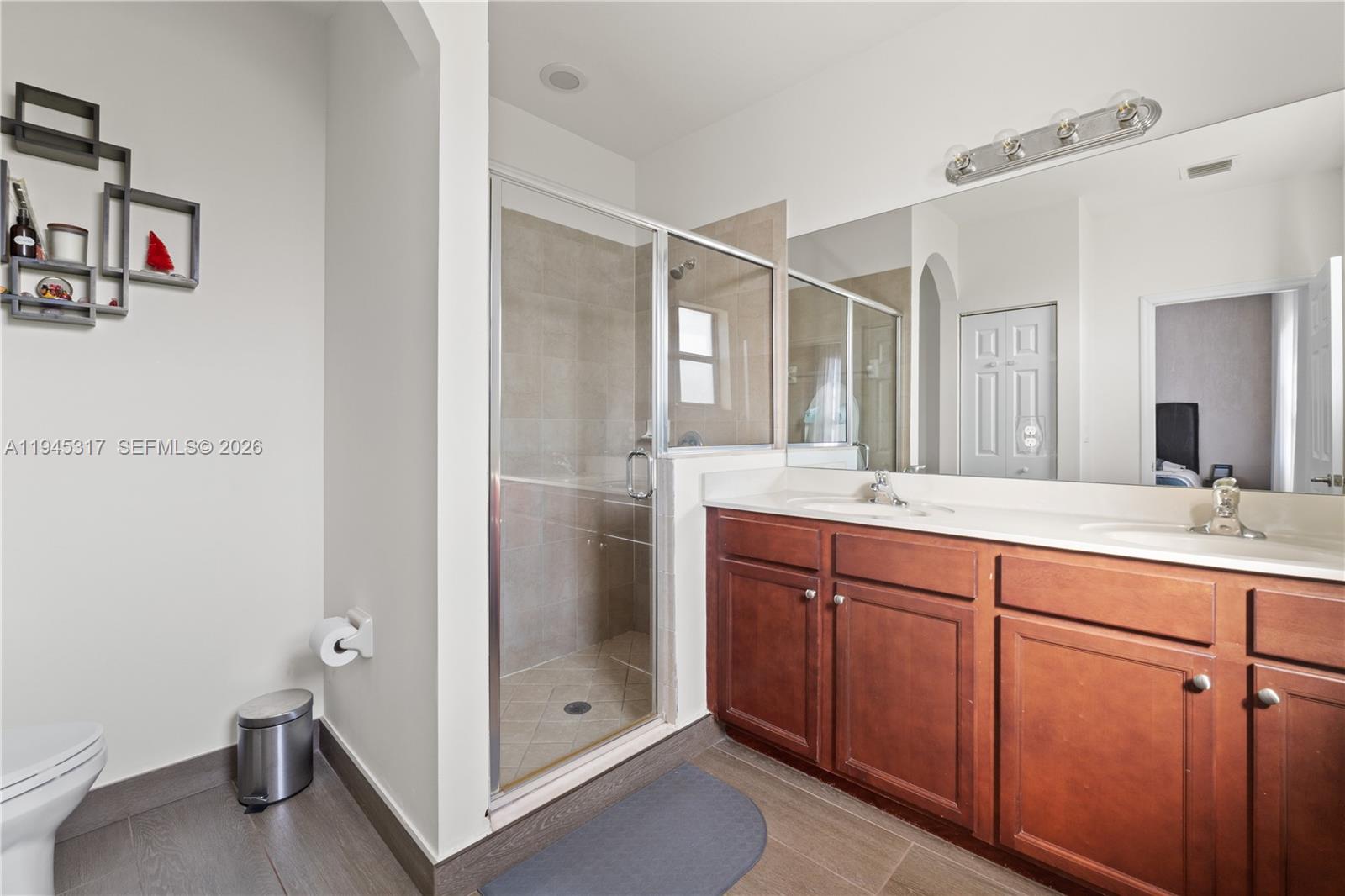 17619 Southwest 153rd Path Miami, FL 33187 - Photo 14 of 35 a spacious bathroom with a shower sink and mirror