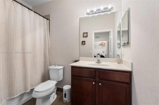 a bathroom with a toilet a sink and a mirror