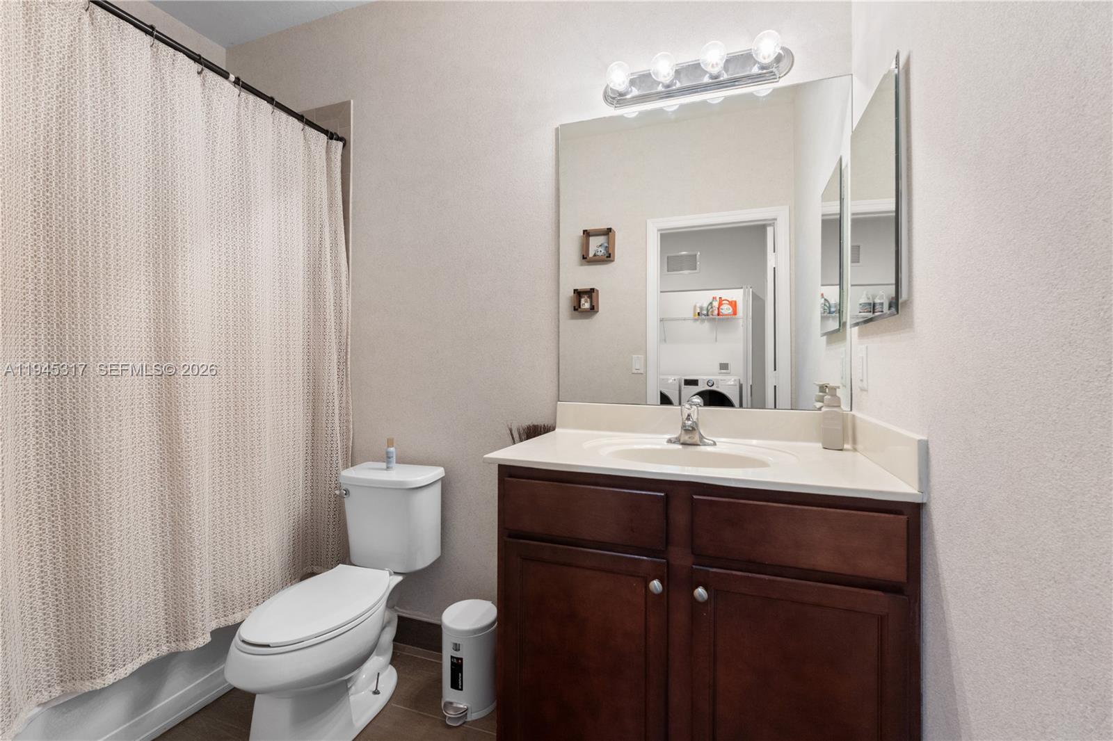 17619 Southwest 153rd Path Miami, FL 33187 - Photo 19 of 35 a bathroom with a toilet a sink and a mirror
