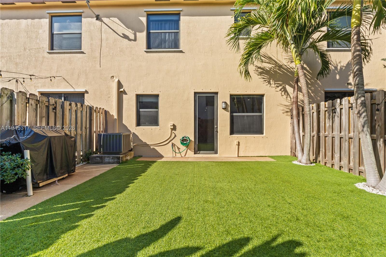 17619 Southwest 153rd Path Miami, FL 33187 - Photo 23 of 35 a view of a house with backyard and wooden fence