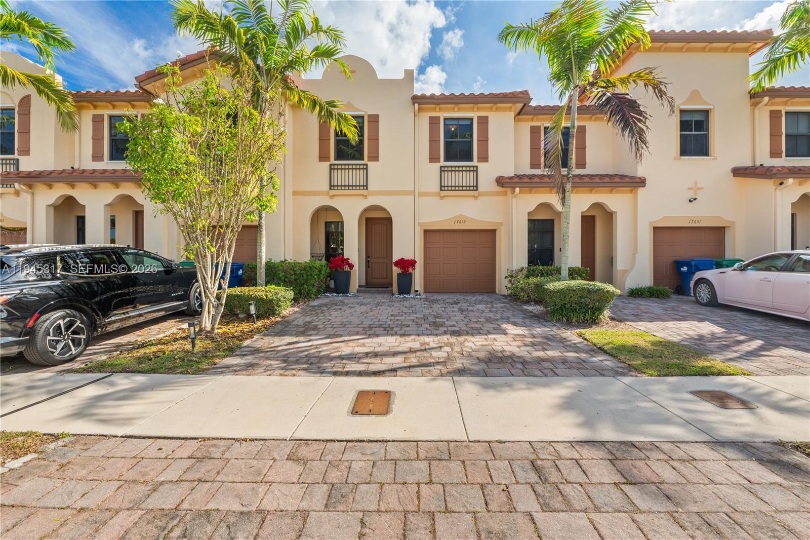 17619 Southwest 153rd Path Miami, FL 33187 - Photo 26 of 35 a view of a white house with large windows next to a road