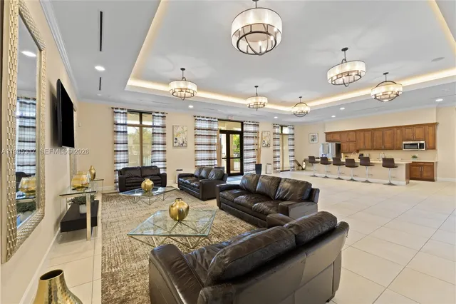 a living room with furniture kitchen view and a large window
