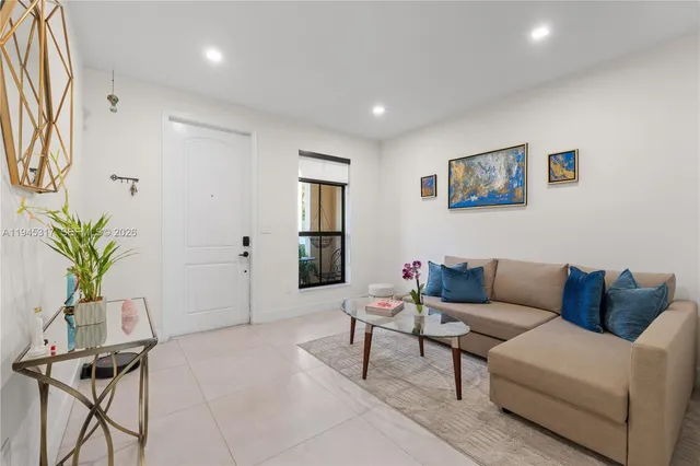 a living room with furniture potted plant and a window