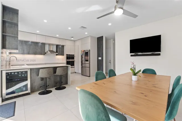 a kitchen with kitchen island a sink stainless steel appliances and cabinets