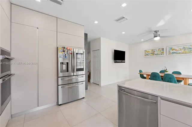 a kitchen with stainless steel appliances a refrigerator and a sink