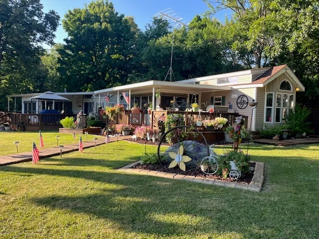 a view of a swimming pool with a patio and a yard