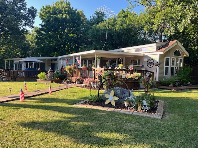 a view of a swimming pool with a patio and a yard