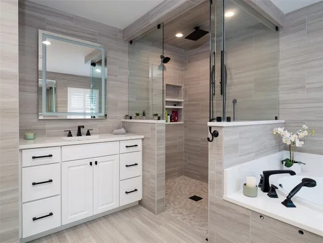 a spacious bedroom with a bed and a flat screen television