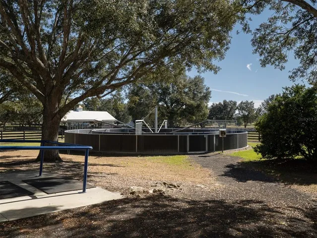 a view of a house with a yard and potted plants