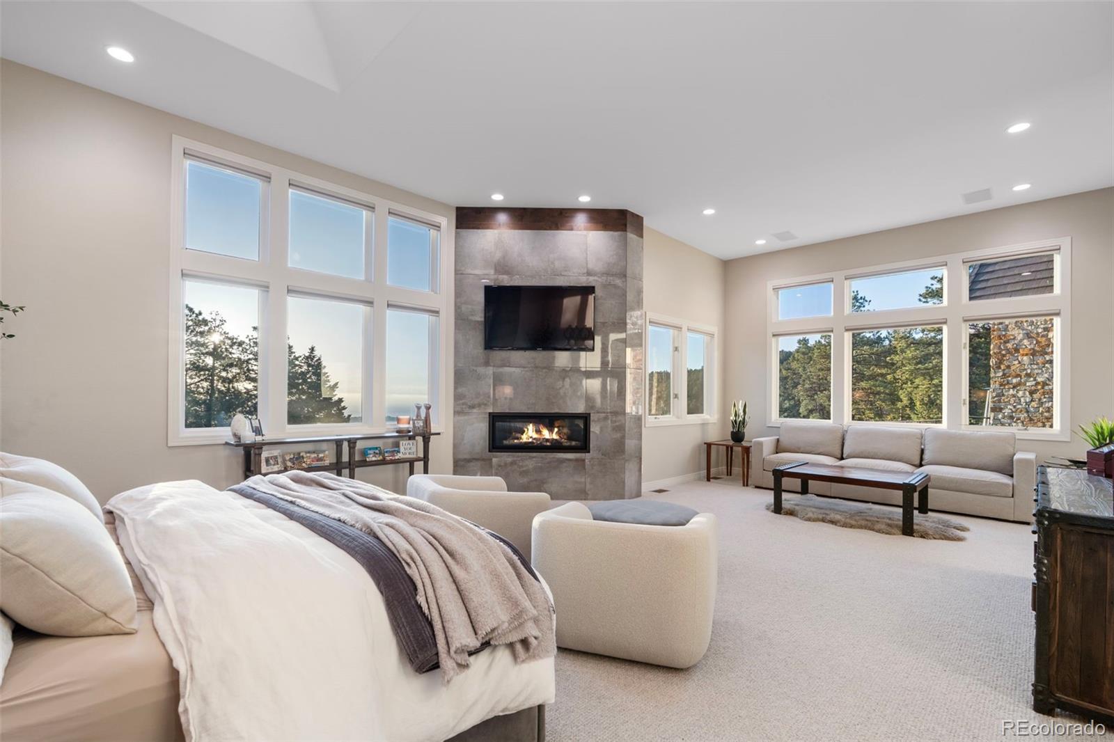 730 Genesee Mountain Road Golden, CO 80401 - Photo 20 of 50 a spacious bedroom with a large bed and a large window