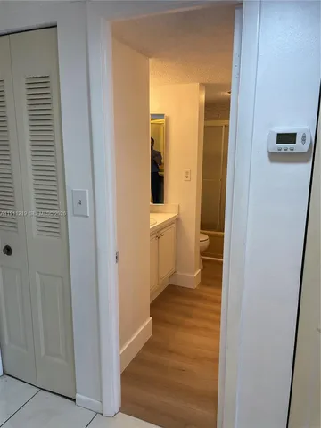 a view with a sink and cabinets