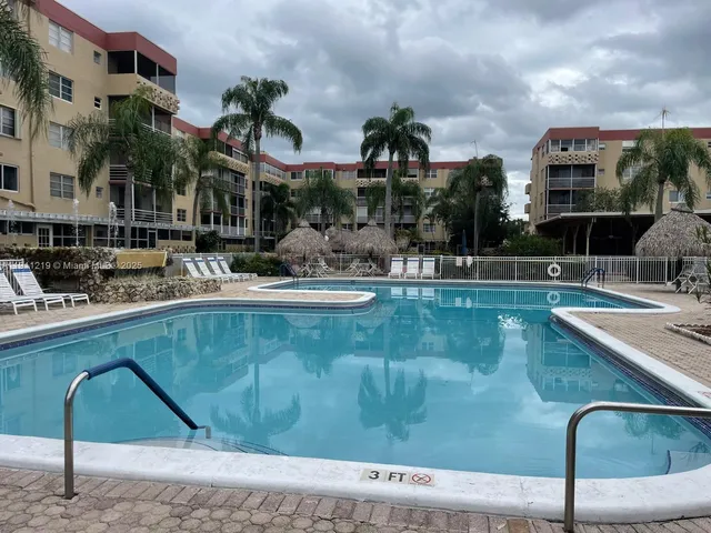 a swimming pool with outdoor seating and yard