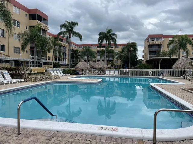 a swimming pool with outdoor seating and yard