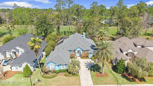 an aerial view of a house with a swimming pool