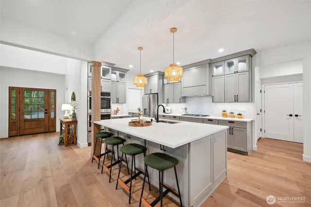a large kitchen with a table and chairs
